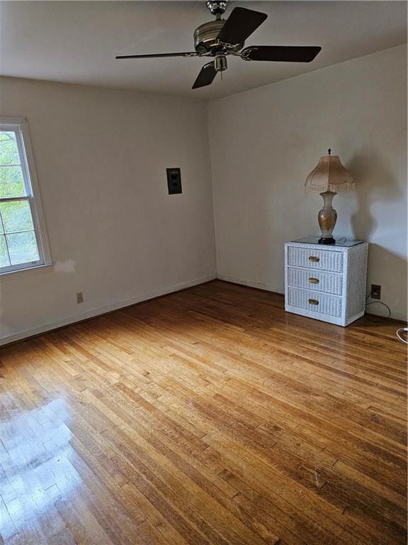 empty room featuring ceiling fan and light hardwood / wood-style floors