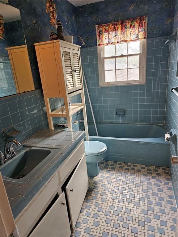 full bathroom featuring vanity, toilet, decorative backsplash, and tiled shower / bath