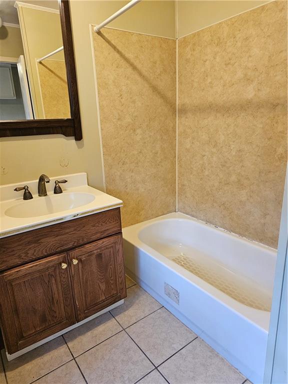 bathroom with vanity, shower / bath combination, and tile patterned floors