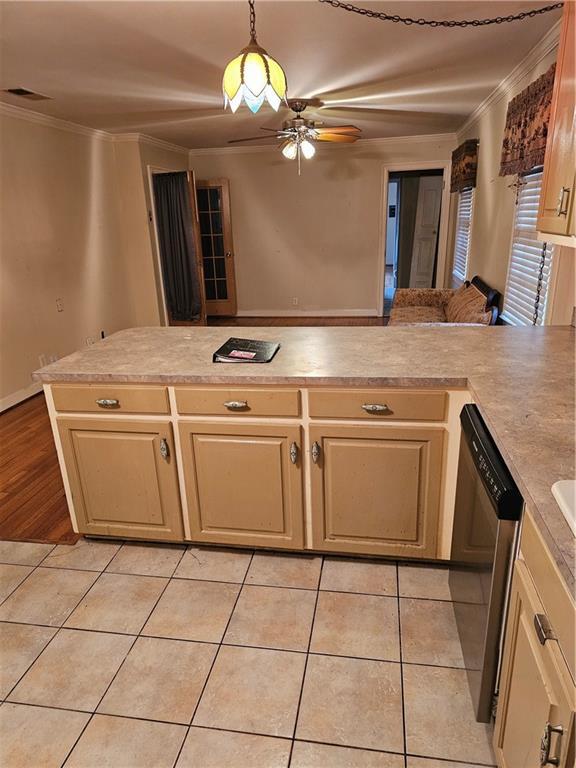 kitchen featuring stainless steel dishwasher, ceiling fan, ornamental molding, and kitchen peninsula