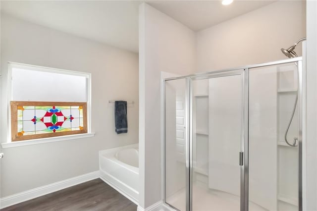 bathroom with plus walk in shower and wood-type flooring