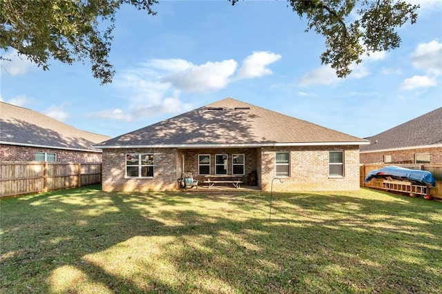 rear view of house with a lawn