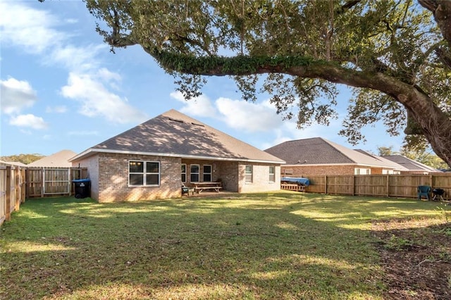 back of house with a yard