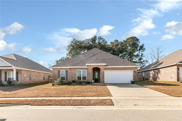 view of front of house featuring central AC unit, a garage, and a front yard