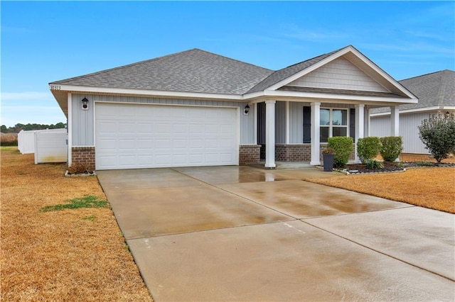 view of front of property featuring a porch, a garage, and a front lawn