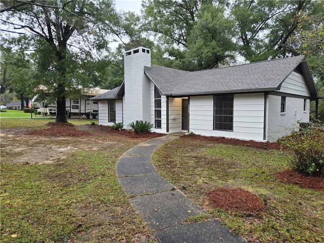 ranch-style house with a front lawn