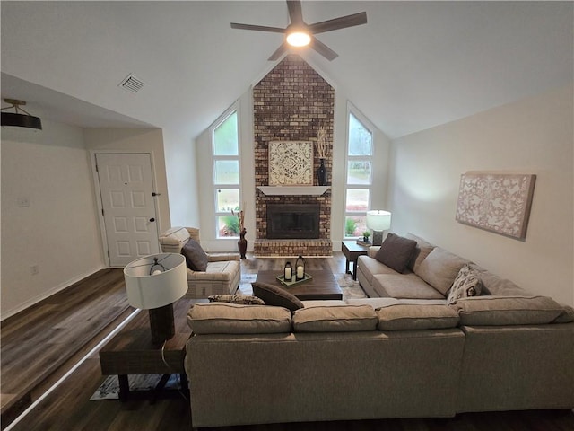 living room featuring a fireplace, ceiling fan, lofted ceiling, and dark wood-type flooring