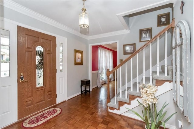 entrance foyer featuring dark parquet flooring and ornamental molding