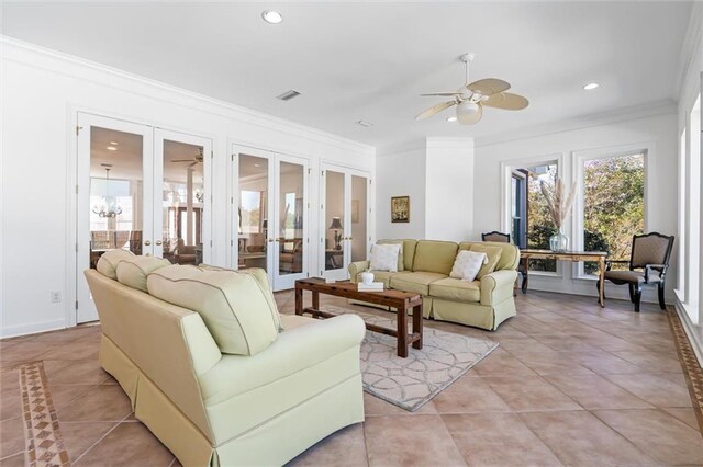 living room with light tile patterned floors, french doors, visible vents, and ornamental molding