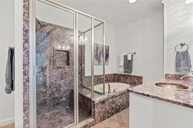 full bath with tile patterned floors, a shower stall, vanity, and a garden tub