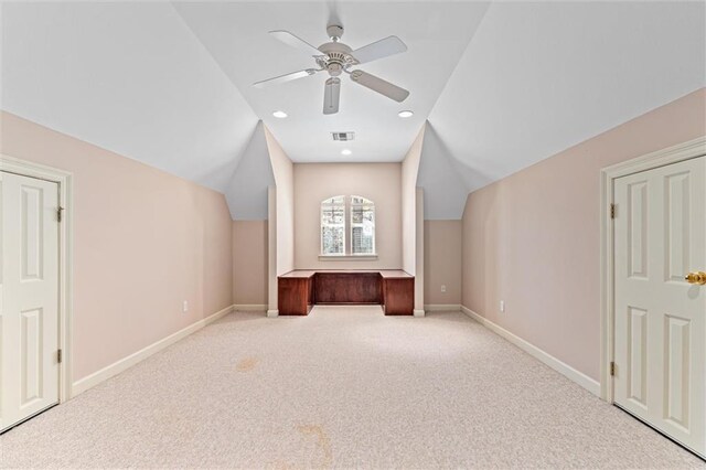 bonus room featuring lofted ceiling, a ceiling fan, baseboards, and carpet floors