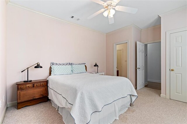 bedroom with baseboards, light colored carpet, visible vents, and ornamental molding