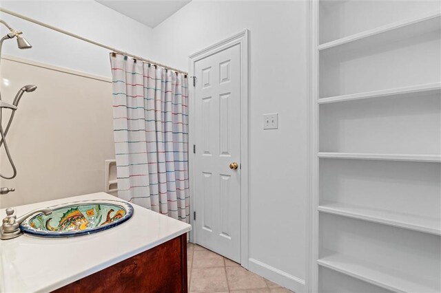 full bath featuring tile patterned floors and vanity