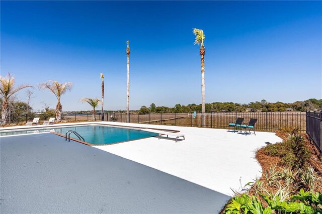 view of swimming pool featuring a fenced in pool, a patio, and fence