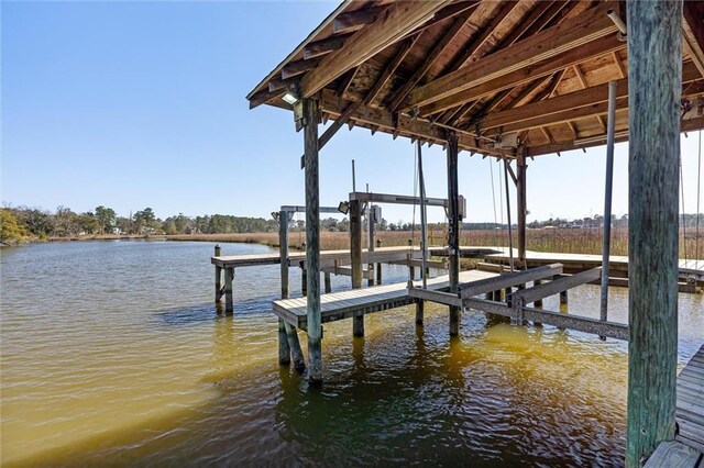 dock area with a water view and boat lift