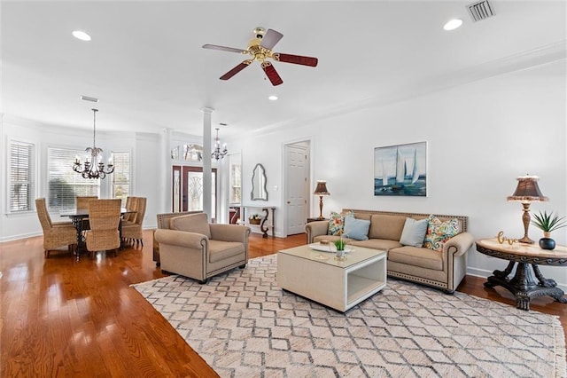 living room with visible vents, baseboards, light wood-type flooring, decorative columns, and recessed lighting