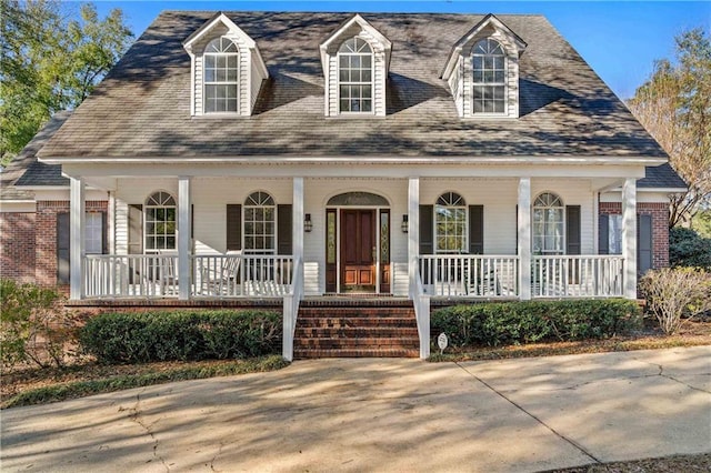 view of front facade with a porch and brick siding