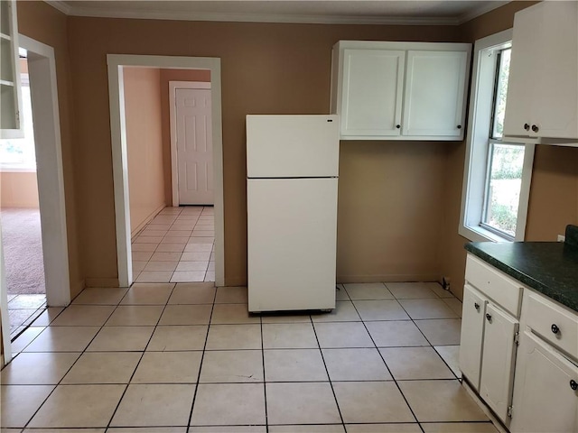kitchen featuring crown molding, white cabinets, and freestanding refrigerator