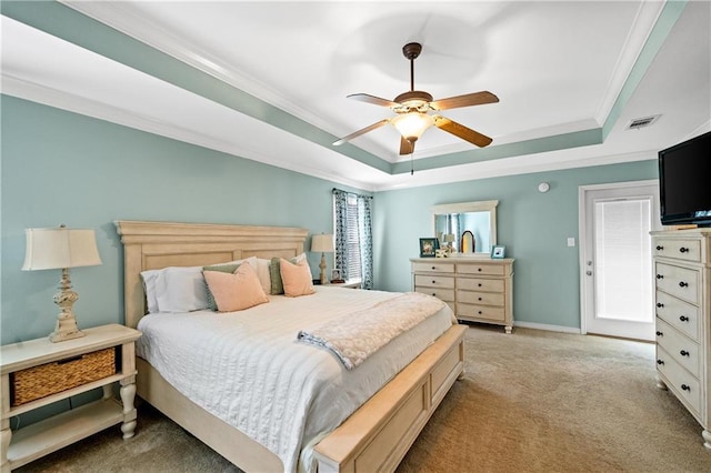 carpeted bedroom featuring a raised ceiling, ceiling fan, and crown molding