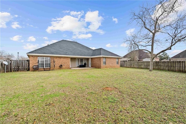 back of property with a patio and a lawn