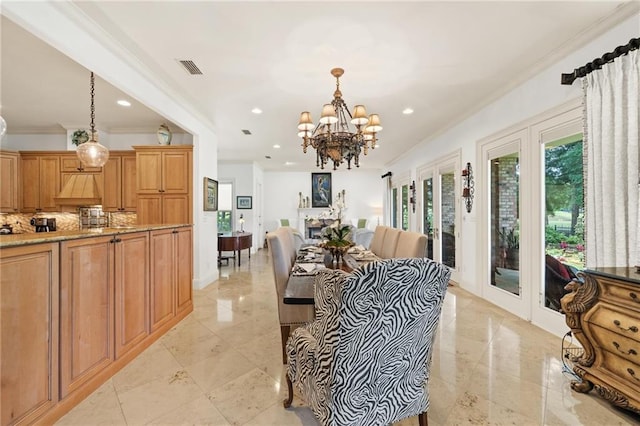 interior space featuring pendant lighting, light tile flooring, crown molding, a chandelier, and light stone counters