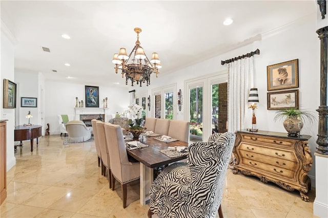 dining area featuring a chandelier, ornamental molding, and light tile floors