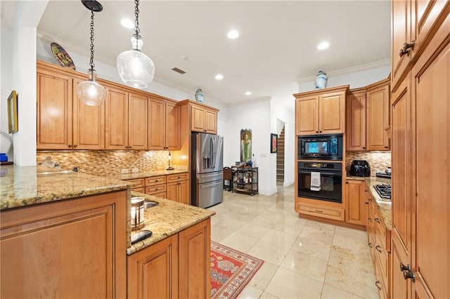 kitchen with decorative light fixtures, tasteful backsplash, black appliances, and light stone countertops