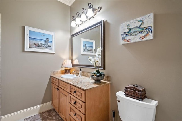 bathroom featuring vanity with extensive cabinet space and toilet