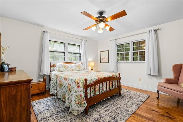 bedroom with ceiling fan and hardwood / wood-style floors