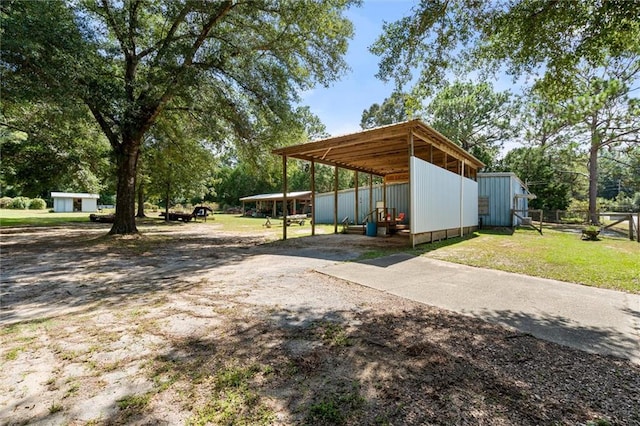 view of yard featuring an outdoor structure and a carport