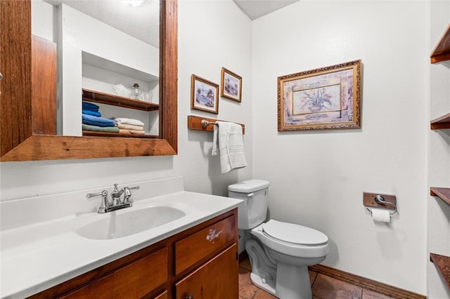 bathroom with tile patterned flooring, vanity, and toilet