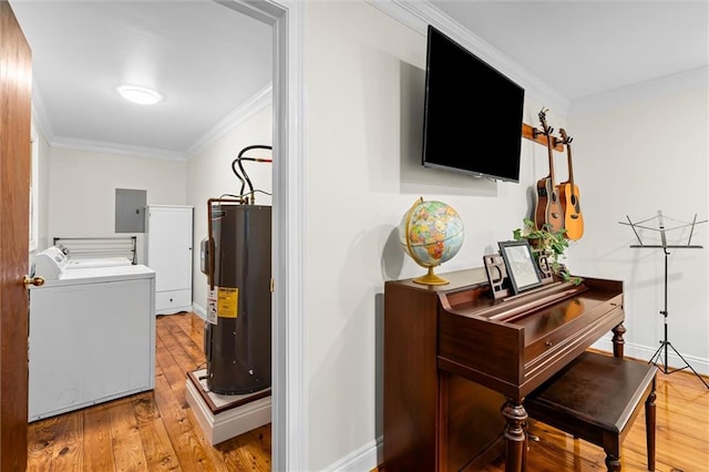 interior space featuring light hardwood / wood-style floors, electric water heater, electric panel, crown molding, and washing machine and dryer