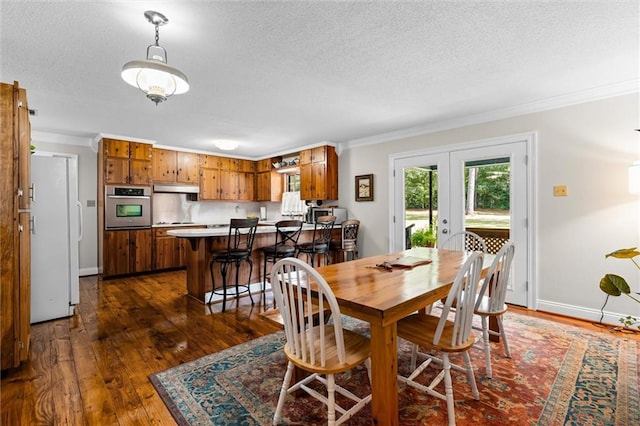 dining space with french doors, ornamental molding, a textured ceiling, and dark hardwood / wood-style flooring