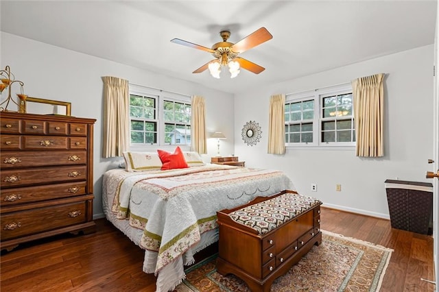 bedroom with ceiling fan, dark hardwood / wood-style floors, and multiple windows