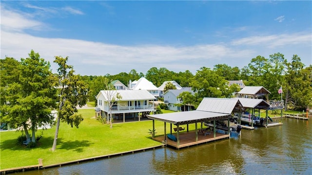 dock area with a lawn and a water view