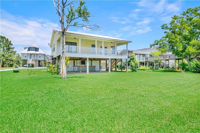 rear view of property with a yard and covered porch