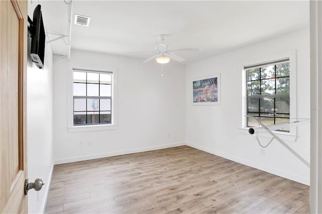 unfurnished room with light wood-type flooring and ceiling fan