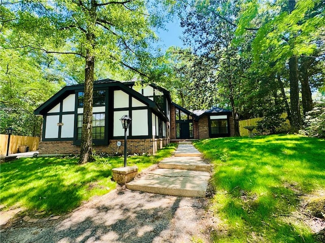 tudor house featuring a front yard