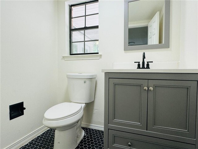 bathroom featuring tile floors, toilet, and vanity