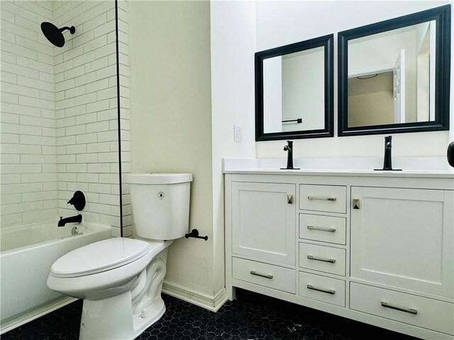 full bathroom featuring tile floors, tiled shower / bath, vanity, and toilet