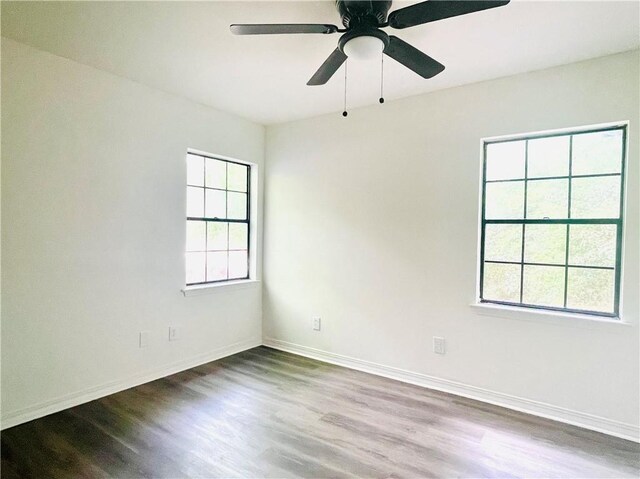 spare room featuring hardwood / wood-style floors and ceiling fan