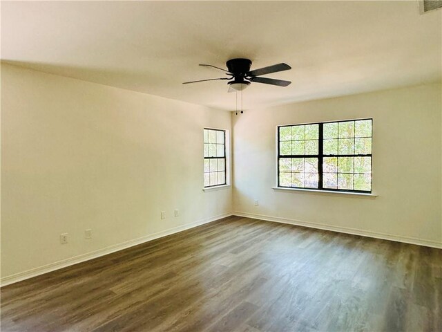 spare room with dark hardwood / wood-style floors and ceiling fan