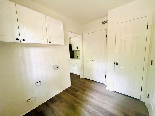 clothes washing area featuring cabinets, hookup for a washing machine, and dark hardwood / wood-style flooring