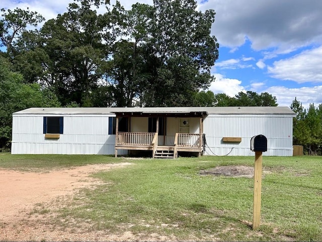 manufactured / mobile home with a deck and a front lawn