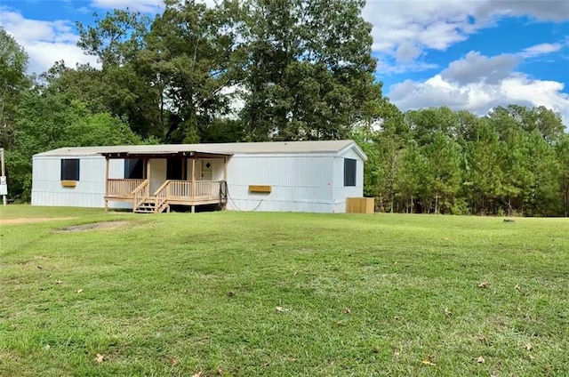 view of front of property featuring a front lawn and a deck