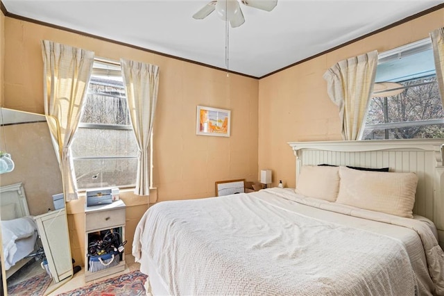 bedroom featuring ceiling fan and ornamental molding