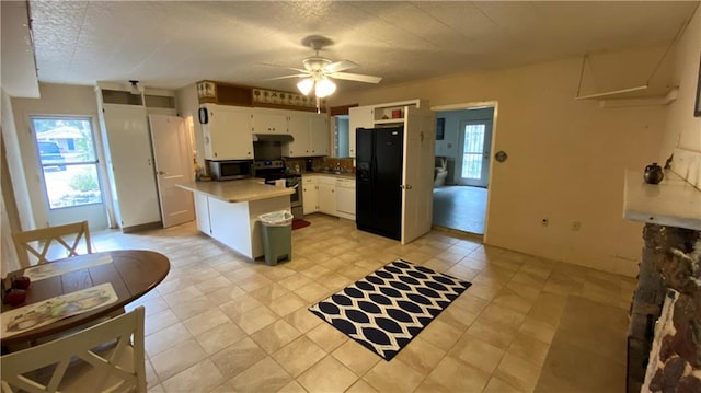 kitchen featuring a ceiling fan, under cabinet range hood, appliances with stainless steel finishes, white cabinets, and light countertops