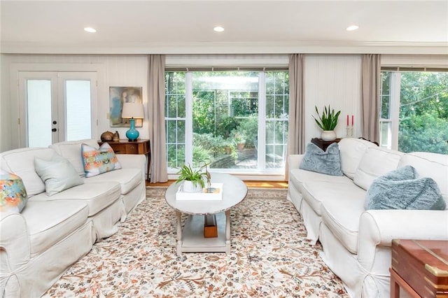 living room featuring french doors, light hardwood / wood-style flooring, and a wealth of natural light