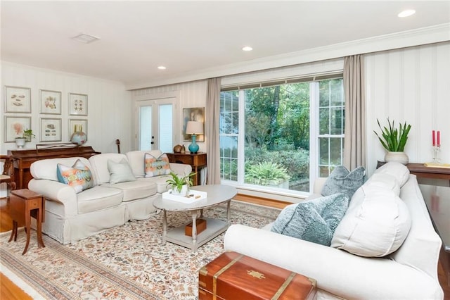 living room with hardwood / wood-style floors and crown molding