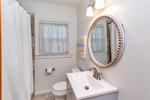 bathroom featuring tile patterned flooring, vanity, and toilet